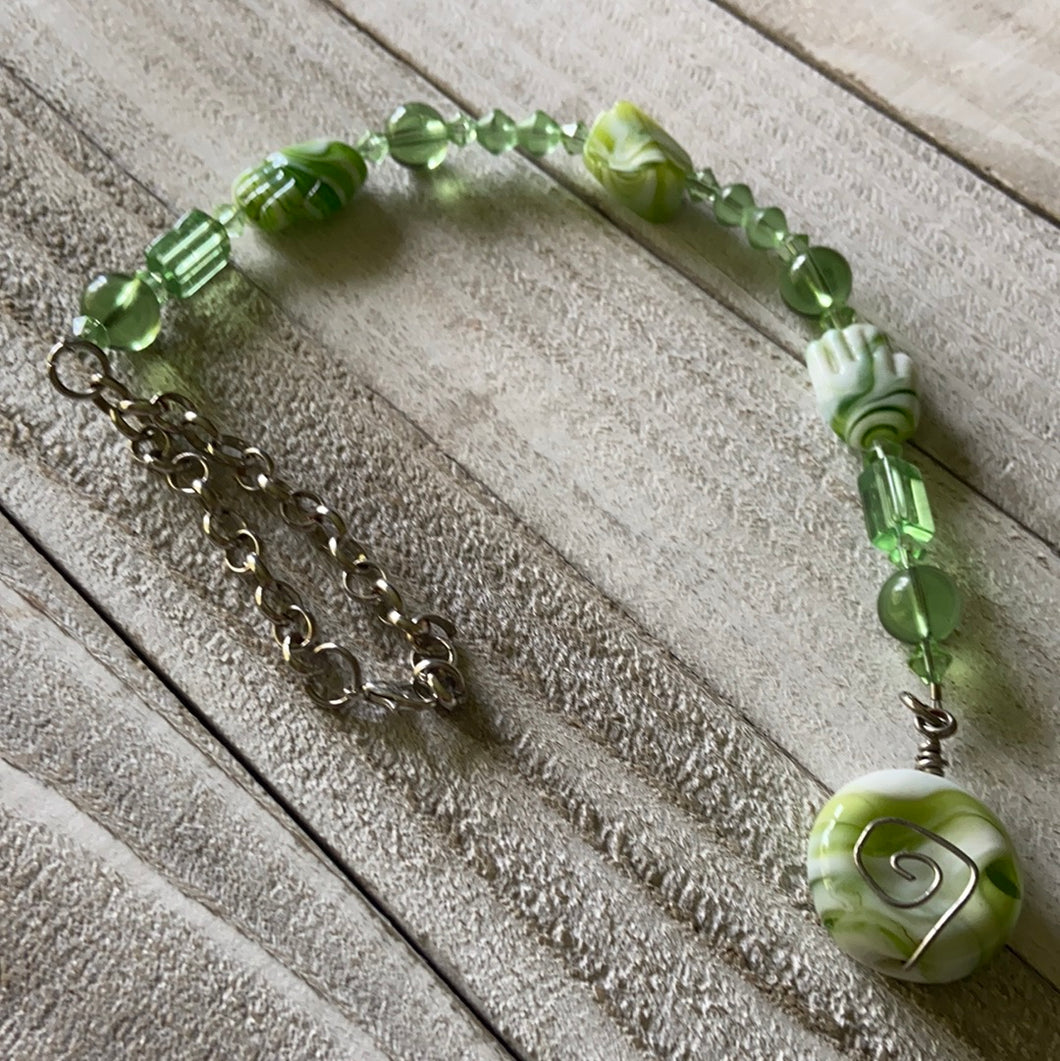 Green and white beaded rearview mirror charm